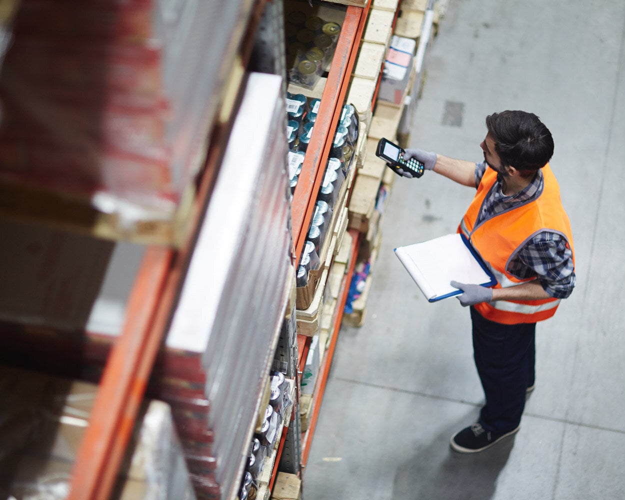 Arbeiter mit Scanner bei der Überprüfung von Waren im Lager
